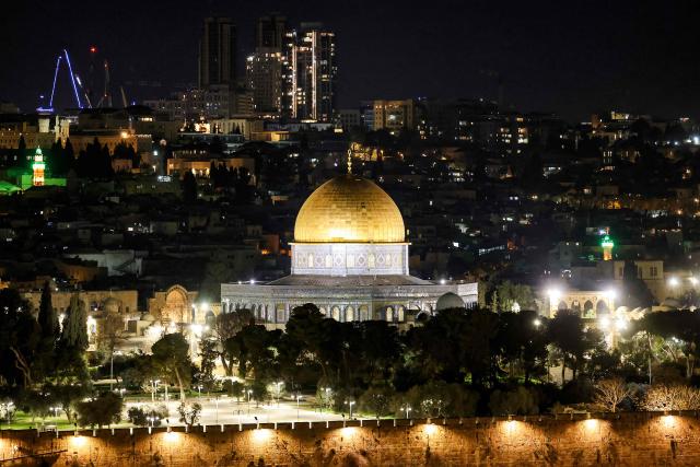 The lit-up Dome of the Rock Shrine in the Aqsa mosque compound in the old city of Jerusalem is pictured at night on March 1, 2026. The United States and Israel launched strikes against Iran on February 28, killing Iran's supreme leader and top military leaders, prompting authorities to retaliate with strikes on Israel and US bases across the Gulf. (Photo by HAZEM BADER / AFP)