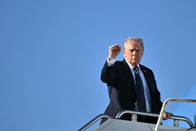 US President Donald Trump gestures as he boards Air Force One before departing Palm Beach International Airport in West Palm Beach, Florida, on March 1, 2026, on his way back to Washington, DC. The United States and Israel launched massive bombardments against Iran and killed its supreme leader on February 28, with attacks ongoing Sunday. The US military on Sunday said three service members have been killed and five seriously wounded in the war against Iran -- the first casualties announced on the US side. (Photo by Mandel NGAN / AFP)