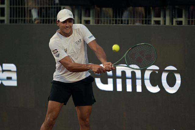 Italy's Luciano Darderi returns the ball to Germany's Yannick Hanfmann during the ATP Santiago Open men's singles tennis final match at the Club San Carlos de Apoquindo in Santiago on March 1, 2026. (Photo by Rodrigo ARANGUA / AFP)