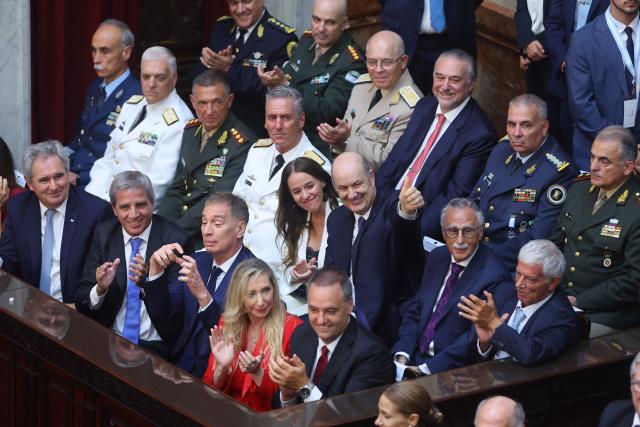 Argentina's President Javier Milei ministers smile as he delivers his annual speech to parliament ahead of the inauguration of the 144th ordinary session of Congress in Buenos Aires on March 1, 2026. (Photo by ALEJANDRO PAGNI / AFP)