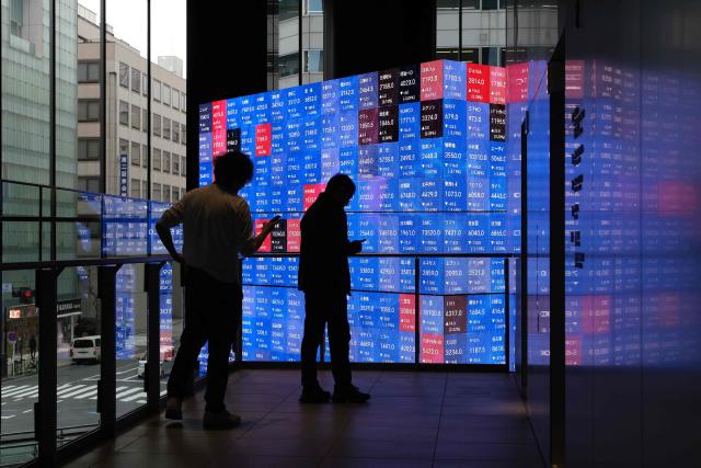 An electronic quotation board displays the Nikkei 225 stock prices on the Tokyo Stock Exchange in Tokyo on March 2, 2026. Asian stocks dropped in early trade March 2 on the back of fears for the global economy following US-Israeli attacks on Iran over the weekend. (Photo by Kazuhiro NOGI / AFP)