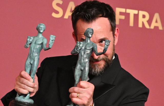 US actor Noah Wyle poses with the awards for Outstanding Performance by a Male Actor in a Drama Series and Outstanding Performance by an Ensemble in a Drama Series for "The Pitt" during the 32nd Annual Actor Awards at the Shrine Auditorium in Los Angeles on March 1, 2026. (Photo by Frederic J. Brown / AFP)