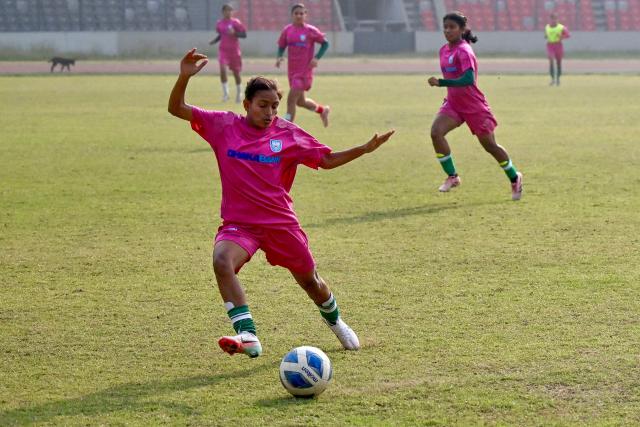 This photograph taken on February 21, 2026 shows Bangladesh women's junior football team taking part in a training session at the National Stadium in Dhaka. Bangladesh's national football team face daunting odds at their first-ever Women's Asian Cup, but have already scored a major victory by qualifying. In the South Asian nation of 170 million, social stigma, family expectations, poverty and religious hardliners have long relegated women and girls to sports sidelines. (Photo by Munir UZ ZAMAN / AFP) / To go with 'FBL-ASIA-2026-WOMEN-BAN' FOCUS