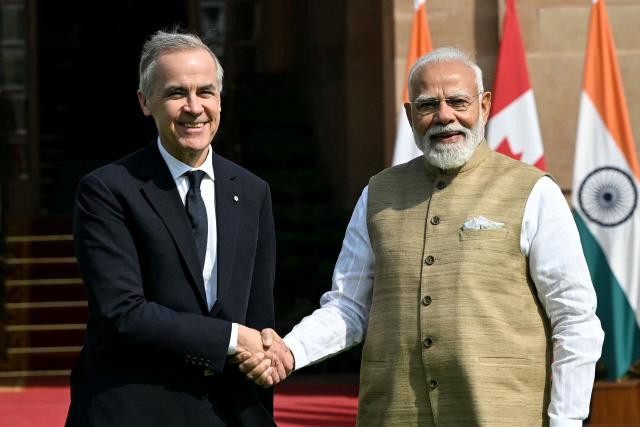 India's Prime Minister Narendra Modi (R) shakes hands with his Canadian counterpart Mark Carney before their meeting at the Hyderabad House in New Delhi on March 2, 2026. (Photo by Sajjad HUSSAIN / AFP)