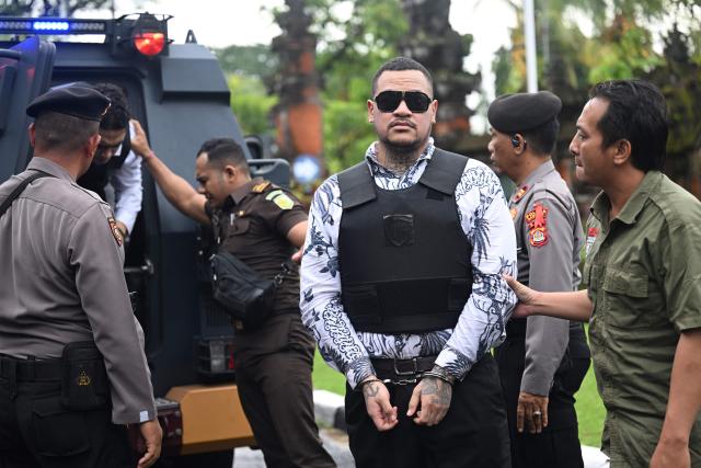 Australian suspect Tupou Pasa Midolmore is escorted to his trial at a courtroom in Denpasar, Indonesia's Bali island, on March 2, 2026. The trial of three Australians accused of plotting the murder of a compatriot at a villa in Bali continues, with all facing the death penalty. (Photo by SONNY TUMBELAKA / AFP)