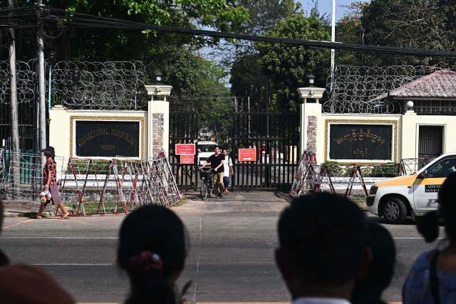 Prisoners, released early to mark Peasants' Day, walk out of the gate of Insein prison in Yangon on March 2, 2026. Myanmar's military junta on March 2 announced amnesties for more than 7,000 prisoners convicted of financing or sheltering a "terrorist group", a designation it has used to outlaw pro-democracy factions opposing its rule. (Photo by Sai Aung MAIN / AFP)