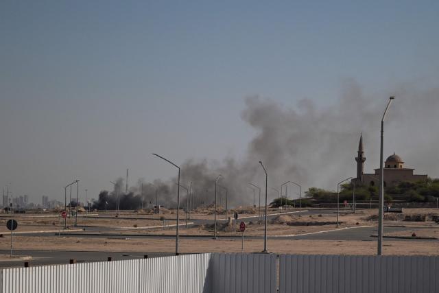 TOPSHOT - Smoke rises from a reported Iranian strike in the area where the US Embassy is located in Kuwait City on March 2, 2026. Black smoke was seen rising from the US embassy in Kuwait City on March 2 after the latest volley of Iranian strikes, an AFP correspondent saw. (Photo by AFP)