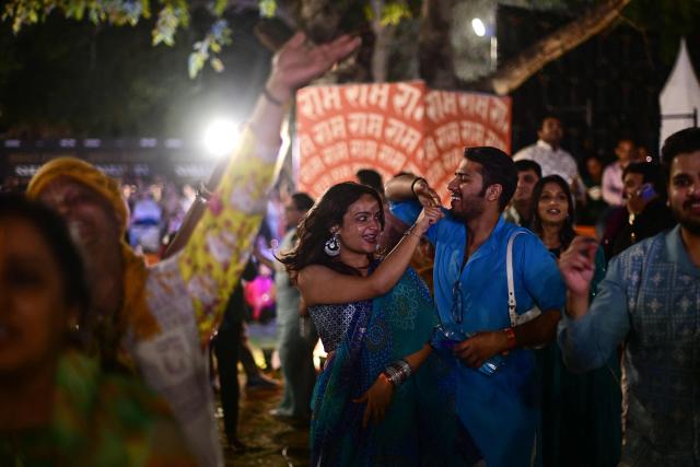Revellers enjoy Hindu spiritual songs called 'Bhajans' during the Sanatan Journey devotional music festival at the iconic Purana Qila in New Delhi on March 1, 2026. 'Bhajan clubbing' and devotional music festivals are emerging as a new cultural wave in India, mixing traditional spiritual songs with the energy of live concerts. Growing in popularity among young Indians, the trend is reshaping how Gen Z experiences faith and modern spirituality. (Photo by Manan VATSYAYANA / AFP)