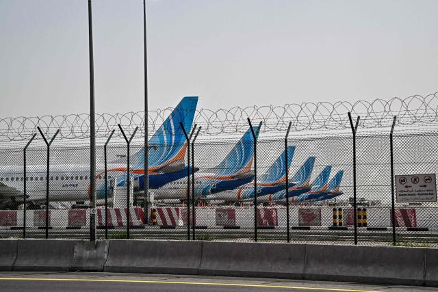 FlyDubai planes are parked on the tarmac at Dubai International Airport as Iran retaliates following the US and Israels assassination of its supreme leader, in Dubai on March 2, 2026. The United States hit hundreds of targets across Iran, and Israel expanded its bombing to Lebanon on March 2 as US President Donald Trump vowed to avenge the first US deaths in the war he launched to topple Tehran's ruling clerics. Iranian forces fired missiles and drones across the Middle East, killing people in Israel and the United Arab Emirates, in retaliation for the conflict that began Saturday with the death of Iran's supreme leader, Ayatollah Ali Khamenei. (Photo by Giuseppe CACACE / AFP)