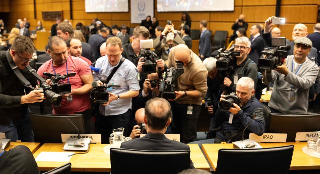 Iran’s ambassador to the International Atomic Energy Agency (IAEA) Reza Najafi (foreground, C) gets some media attention as he attends the special meeting on Iran, initiated by Russia, prior to the IAEA’s Board of Governors meeting at the agency's headquarters in Vienna, Austria on March 2, 2026. Delegates at the United Nations' nuclear agency began meeting on Monday for an extraordinary session on Iran in the wake of the US-Israeli strikes on the Islamic republic. Russia, a key ally of Tehran, requested the meeting at the Vienna-based International Atomic Energy Agency (IAEA), following the same request by Iran. The extraordinary meeting precedes an already scheduled regular session of the IAEA's board of governors, which represents 35 countries. (Photo by Joe Klamar / AFP)