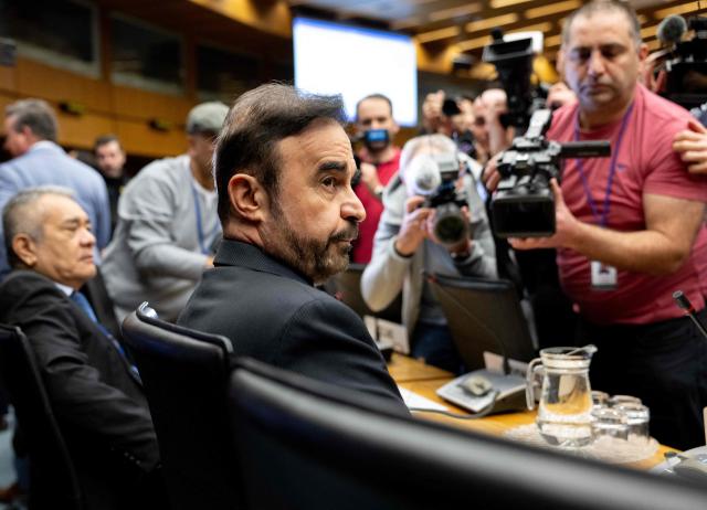 Iran’s ambassador to the International Atomic Energy Agency (IAEA) Reza Najafi (C) attends the special meeting on Iran, initiated by Russia, prior to the IAEA’s Board of Governors meeting at the agency's headquarters in Vienna, Austria on March 2, 2026. Delegates at the United Nations' nuclear agency began meeting on Monday for an extraordinary session on Iran in the wake of the US-Israeli strikes on the Islamic republic. Russia, a key ally of Tehran, requested the meeting at the Vienna-based International Atomic Energy Agency (IAEA), following the same request by Iran. The extraordinary meeting precedes an already scheduled regular session of the IAEA's board of governors, which represents 35 countries. (Photo by Joe Klamar / AFP)