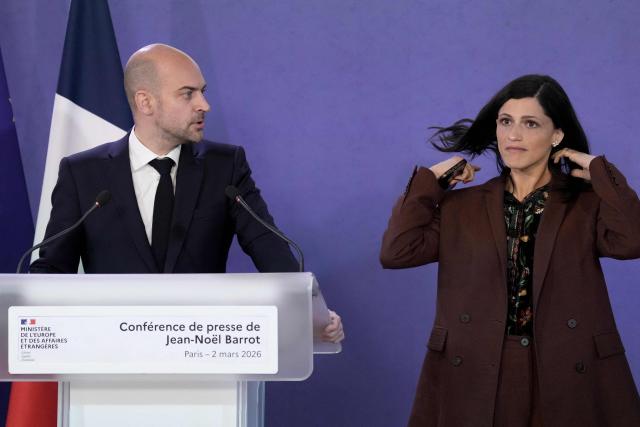 France's Foreign Affairs Minister Jean-Noel Barrot (L) and France’s junior Minister in charge of global Francophones and expatriates Eleonore Caroit give a press conference after a crisis meeting in Paris on March 2, 2026, following the conflict across the Middle East region after the massive Israel-US attack on Iran to topple Tehran's ruling clerics. (Photo by Thibault Camus / POOL / AFP)