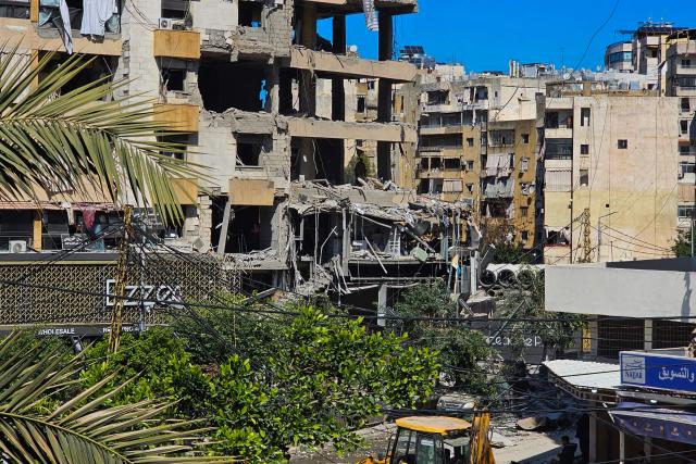 A man (C-back) inspects a building damaged in an Israeli airstrike in the southern suburb of Haret Hreik of Beirut the on March 2, 2026. Israel bombarded Lebanon on March 2, expanding conflict across the region after the massive Israel-US attack on Iran that President Donald Trump launched to topple Tehran's ruling clerics. (Photo by AFP)