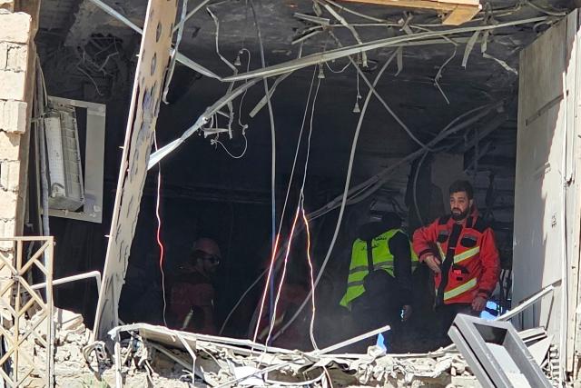 First responders inspect a building damaged in an Israeli airstrike in the southern suburb of Haret Hreik of Beirut the on March 2, 2026. Israel bombarded Lebanon on March 2, expanding conflict across the region after the massive Israel-US attack on Iran that President Donald Trump launched to topple Tehran's ruling clerics. (Photo by AFP)