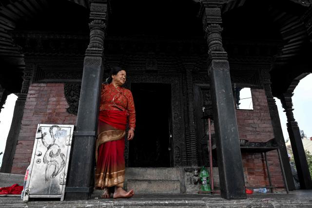 A woman stands in a temple complex in Kathmandu on March 2, 2026 ahead of parliamentary elections in Nepal. (Photo by Tauseef MUSTAFA / AFP)