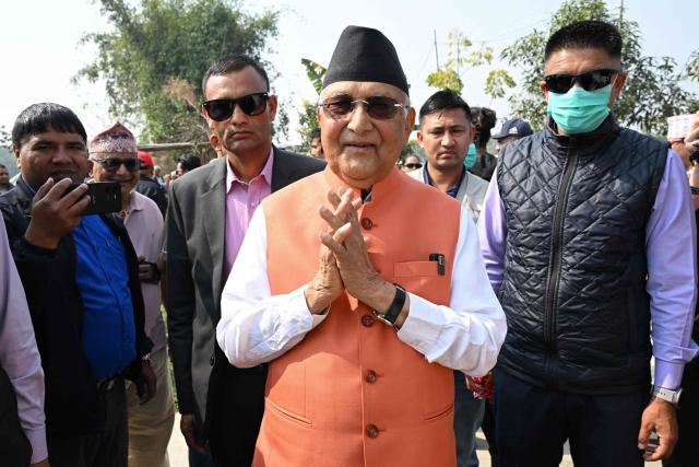 Khadga Prasad Sharma Oli (C), Nepal's former prime minister and Communist Party of Nepal-Unified Marxist Leninist (CPN-UML) leader, greets supporters during a rally on the final day of campaigning ahead of the country's general election at Gauradaha in Jhapa district on March 2, 2026. (Photo by Prakash MATHEMA / AFP)