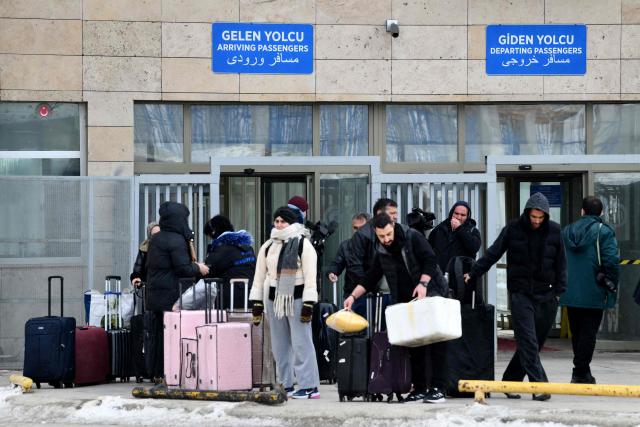 Iranian nationals arrive in northeastern Turkey after passing through the Razi-Kapikoy border crossing in Van, on March 2, 2026 as Turkey and Iran have mutually suspended day-trip crossings at their border, Turkey's trade minister said as Israeli-US strikes continued to pound the Islamic Republic. (Photo by Ali IHSAN OZTURK / AFP)