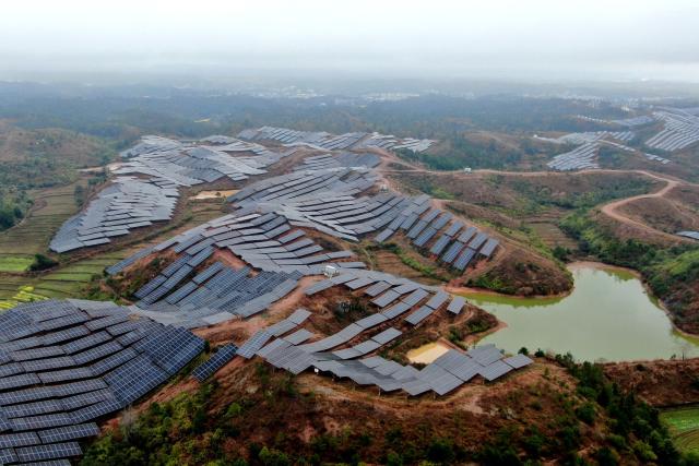 This photo shows an aerial view of solar panels covering mountainsides in Xinxi village, Suichuan county, in China's central Jiangxi province on March 2, 2026. (Photo by CN-STR / AFP) / China OUT