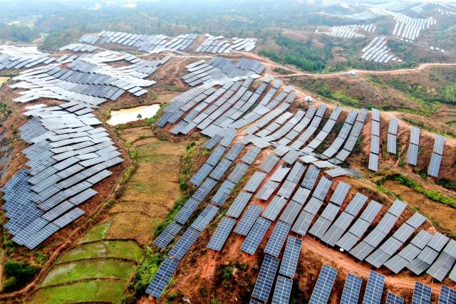 This photo shows an aerial view of solar panels covering mountainsides in Xinxi village, Suichuan county, in China's central Jiangxi province on March 2, 2026. (Photo by CN-STR / AFP) / China OUT