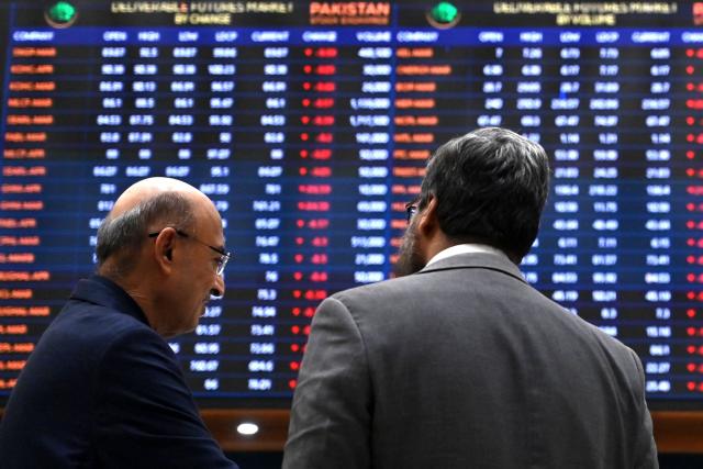 Stockbrokers react while monitoring share prices at the Pakistan Stock Exchange (PSX) in Karachi on March 2, 2026. (Photo by Asif HASSAN / AFP)