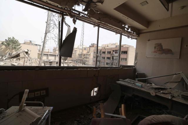 A view of the damage seen from inside the Gandi Hospital, which was hit March 1, when a projectile struck a state TV communications tower (outside) and nearby buildings, during the ongoing joint US-Israeli military campaign on the capital Tehran on March 2, 2026. The United States and Israel launched strikes against Iran on February 28, killing Iran's supreme leader and top military leaders, prompting authorities to retaliate with strikes on Israel and across the Gulf. (Photo by ATTA KENARE / AFP)