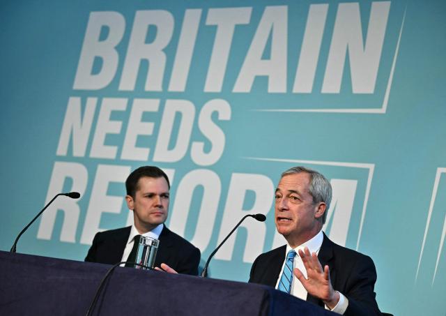 Reform UK's Treasury spokesperson, Robert Jenrick (L) listens as leader Nigel Farage speaks during a party press conference in central London on March 2, 2026. (Photo by Ben STANSALL / AFP)