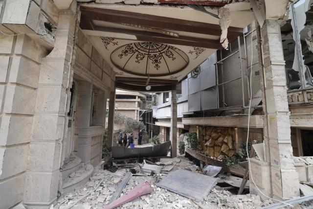 The damaged facade of the Gandi Hospital, which was hit March 1, when a projectile struck a state TV communications tower and nearby buildings across the street, during the ongoing joint US-Israeli military campaign on the capital Tehran on March 2, 2026. The United States and Israel launched strikes against Iran on February 28, killing Iran's supreme leader and top military leaders, prompting authorities to retaliate with strikes on Israel and across the Gulf. (Photo by ATTA KENARE / AFP)