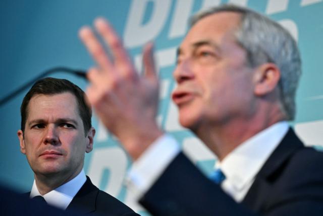 Reform UK's Treasury spokesperson, Robert Jenrick (L) listens as leader Nigel Farage speaks during a party press conference in central London on March 2, 2026. (Photo by Ben STANSALL / AFP)