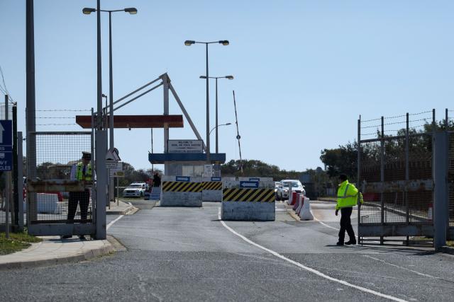 Security personnel man a gate at RAF Akrotiri following two reported drone attacks near Limassol on March 2, 2026. The British sovereign base in Cyprus was being evacuated on March after sirens sounded, an AFP correspondent said. (Photo by Alex MITA / AFP)