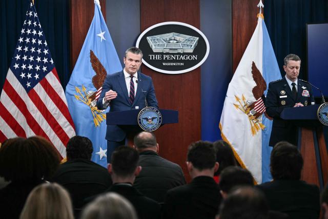 (L/R) US Defense Secretary Pete Hegseth and the Chairman of the Joint Chiefs of Staff General Dan Caine speak during a press conference on US military action in Iran, at the Pentagon in Washington, DC, on March 2, 2026. The United States hit hundreds of targets across Iran, and Israel expanded its bombing to Lebanon on Monday as President Donald Trump vowed to avenge the first US deaths in the war he launched to topple Tehran's ruling clerics. Iranian forces fired missiles and drones across the Middle East, killing people in Israel and the United Arab Emirates, in retaliation for the conflict that began February 28 with the death of Iran's supreme leader, Ayatollah Ali Khamenei. (Photo by Brendan SMIALOWSKI / AFP)