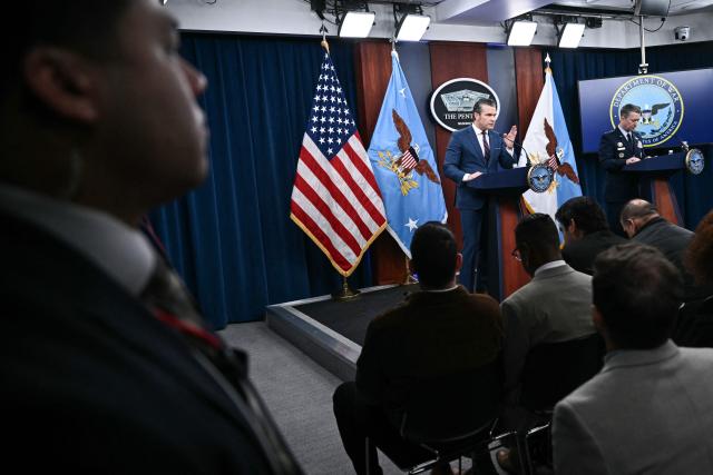 (L/R) US Defense Secretary Pete Hegseth and the Chairman of the Joint Chiefs of Staff General Dan Caine speak during a press conference on US military action in Iran, at the Pentagon in Washington, DC, on March 2, 2026. The United States hit hundreds of targets across Iran, and Israel expanded its bombing to Lebanon on Monday as President Donald Trump vowed to avenge the first US deaths in the war he launched to topple Tehran's ruling clerics. Iranian forces fired missiles and drones across the Middle East, killing people in Israel and the United Arab Emirates, in retaliation for the conflict that began February 28 with the death of Iran's supreme leader, Ayatollah Ali Khamenei. (Photo by Brendan SMIALOWSKI / AFP)