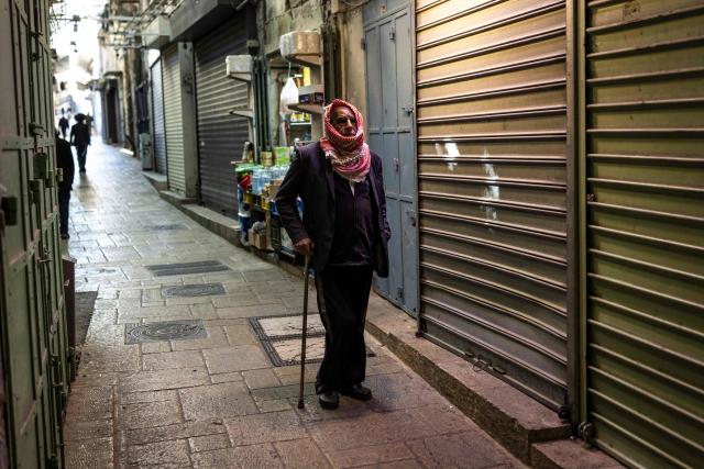 A Palestinian man walks down an empty street inside the Old city of Jerusalem on March 2, 2026. The United States and Israel launched strikes against Iran on February 28, with the killing of Iran's supreme leader and the Islamic republic retaliated with barrages of missiles at Gulf states and Israel. (Photo by JOHN WESSELS / AFP)