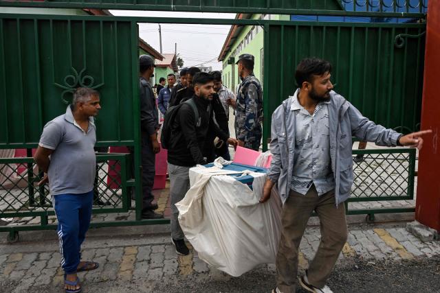 Polling officials carry ballot boxes and other materials at Damak in Jhapa district on March 2, 2026 ahead of parliamentary elections in Nepal. Nepal's election campaign entered its final day on March 2, six months after deadly anti-corruption protests toppled the government, with rival leaders making a last push in a tightly contested race. (Photo by Prakash MATHEMA / AFP)