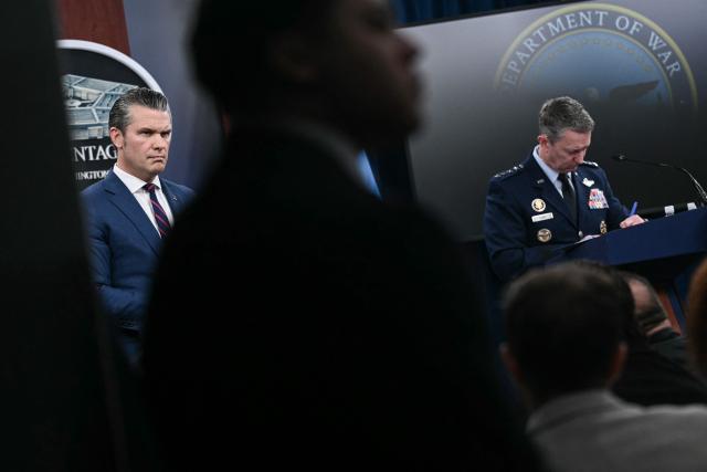 (L/R) US Defense Secretary Pete Hegseth and the Chairman of the Joint Chiefs of Staff General Dan Caine speak during a press conference on US military action in Iran, at the Pentagon in Washington, DC, on March 2, 2026. The United States hit hundreds of targets across Iran, and Israel expanded its bombing to Lebanon on Monday as President Donald Trump vowed to avenge the first US deaths in the war he launched to topple Tehran's ruling clerics. Iranian forces fired missiles and drones across the Middle East, killing people in Israel and the United Arab Emirates, in retaliation for the conflict that began February 28 with the death of Iran's supreme leader, Ayatollah Ali Khamenei. (Photo by Brendan SMIALOWSKI / AFP)
