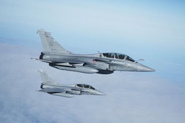 French Air Force Dassault Rafale B aircrafts escort an Airbus A330 MRTT (Multi Role Tanker Transport) refueling aircraft transporting France's President during a flight display, moments before its' landing at the Nuclear Submarine Navy Base of Ile Longue in Crozon, north-western France on March 2, 2026. High expectations, few certainties: on March 2, 2026, Emmanuel Macron is set to outline how France's nuclear deterrent can help strengthen security in Europe in the face of a increasingly brutal world and an increasingly uncertain American ally. This issue has been brought sharply into focus by the Israeli-American offensive in Iran this weekend, against the backdrop of the Iranian nuclear crisis, which is shaking the entire Middle East and, by extension, the international community. (Photo by Yoan VALAT / POOL / AFP)