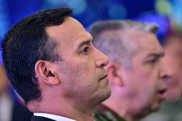 Colombia's Defense Minister, Pedro Arnulfo Sanchez, listens to Commander-in-Chief of the Colombian Armed Forces, Hugo Lopez Barreto (background), during a press conference to inform about the security measures to be implemented for the next legislative and presidential elections at the National Police headquarters in Bogota on March 2, 2026. Colombia will hold legislative elections on March 8 and presidential elections on May 31. (Photo by Pablo VERA / AFP)