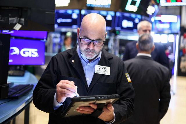Traders work on the floor of the New York Stock Exchange (NYSE) at the opening bell on March 2, 2026, in New York City. Wall Street stocks fell early Monday as the war initiated by US-Israeli attacks on Iran expanded across the Middle East, lifting oil prices. (Photo by CHARLY TRIBALLEAU / AFP)