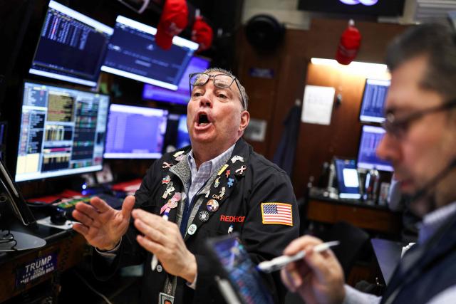 Traders work on the floor of the New York Stock Exchange (NYSE) at the opening bell on March 2, 2026, in New York City. Wall Street stocks fell early Monday as the war initiated by US-Israeli attacks on Iran expanded across the Middle East, lifting oil prices. (Photo by CHARLY TRIBALLEAU / AFP)