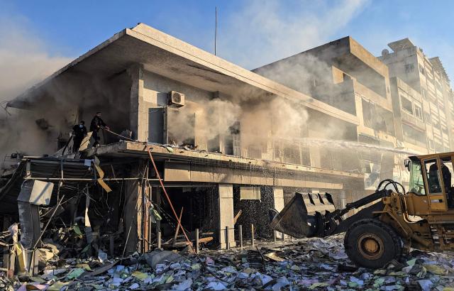 Firefighters extinguish fire at the site of an Israeli airstrike that targeted the offices of Al-Qard al-Hassan, a Hezbollah-linked financial institution, in the southern coastal Lebanese city of Tyre on March 2, 2026. Israel bombarded Lebanon on March 2, expanding the conflict across the region after the massive Israel-US attack on Iran that the US president launched to topple Tehran's ruling clerics, and killing their supreme leader o February 28. (Photo by KAWNAT HAJU / AFP)