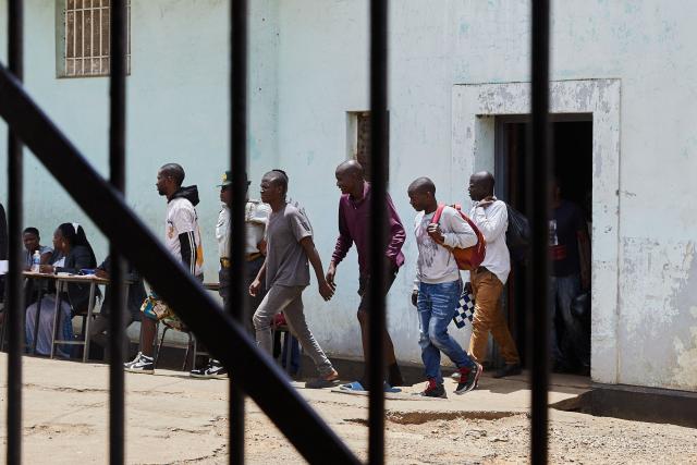 Inmates who qualified to be releaased from prison during an amnesty granted by Zimbabwe President Emmerson Mnangagwa walk a step towards freedom on March 2, 2026. Zimbabwe on Monday began releasing nearly 4,000 inmates who were granted presidential amnesty in a bid to ease overcrowding in prisons.
The cabinet announced the amnesty in February on the same day it approved sweeping changes to the constitution as part of a plan to extend 83-year-old President Emmerson Mnangagwa's term till 2030.
"The nation should note that the release of the 3,978 beneficiaries begins today," Justice Minister Ziyambi Ziyambi said at a press conference in the capital Harare.
Zimbabwe's prisons held just over 24,000 inmates in the second quarter of 2025, according to recent available national data. (Photo by Jekesai NJIKIZANA / AFP)