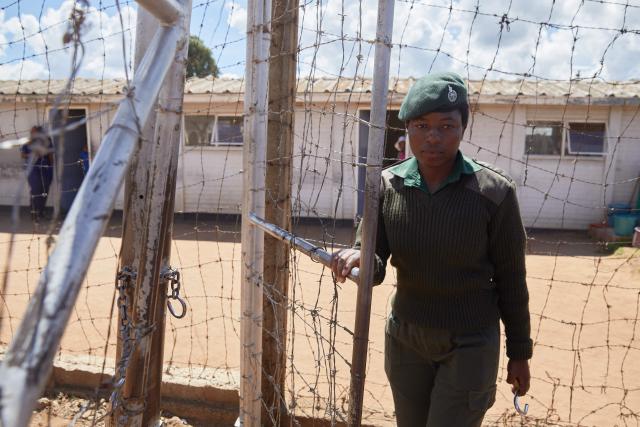 A female prison guard opens the gate for women inmates who qualified to be releaased from prison during an amnesty granted by Zimbabwe President Emmerson Mnangagwa walk a step towards freedom at Chikurubi Womens Prison on March 2, 2026. Zimbabwe on Monday began releasing nearly 4,000 inmates who were granted presidential amnesty in a bid to ease overcrowding in prisons.
The cabinet announced the amnesty in February on the same day it approved sweeping changes to the constitution as part of a plan to extend 83-year-old President Emmerson Mnangagwa's term till 2030.
"The nation should note that the release of the 3,978 beneficiaries begins today," Justice Minister Ziyambi Ziyambi said at a press conference in the capital Harare.
Zimbabwe's prisons held just over 24,000 inmates in the second quarter of 2025, according to recent available national data. (Photo by Jekesai NJIKIZANA / AFP)