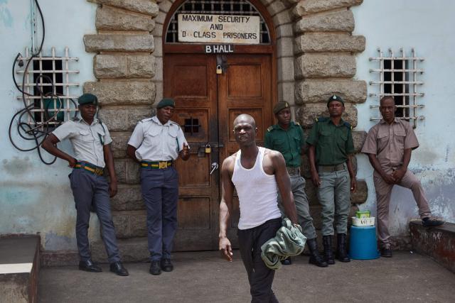 TOPSHOT - An inmates who qualified to be releaased from prison during an amnesty granted by Zimbabwe President Emmerson Mnangagwa walks a step towards freedom on March 2. 2026. Zimbabwe on Monday began releasing nearly 4,000 inmates who were granted presidential amnesty in a bid to ease overcrowding in prisons.
The cabinet announced the amnesty in February on the same day it approved sweeping changes to the constitution as part of a plan to extend 83-year-old President Emmerson Mnangagwa's term till 2030.
"The nation should note that the release of the 3,978 beneficiaries begins today," Justice Minister Ziyambi Ziyambi said at a press conference in the capital Harare.
Zimbabwe's prisons held just over 24,000 inmates in the second quarter of 2025, according to recent available national data. (Photo by Jekesai NJIKIZANA / AFP)