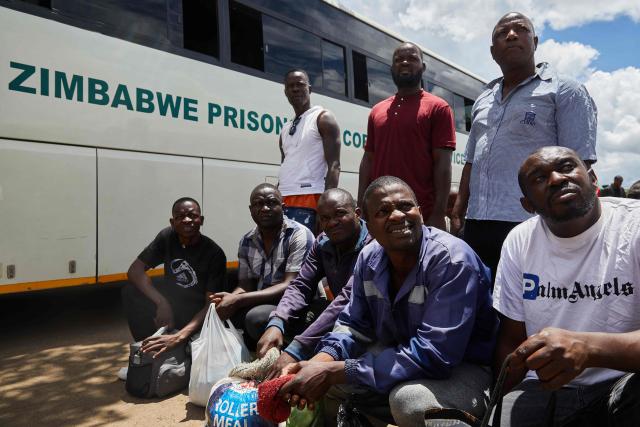 Former inmates at Harare Central Prison listen for their names as they await to board a bus into town moments after their release on March 2, 2026. Zimbabwe on Monday began releasing nearly 4,000 inmates who were granted presidential amnesty in a bid to ease overcrowding in prisons.
The cabinet announced the amnesty in February on the same day it approved sweeping changes to the constitution as part of a plan to extend 83-year-old President Emmerson Mnangagwa's term till 2030.
"The nation should note that the release of the 3,978 beneficiaries begins today," Justice Minister Ziyambi Ziyambi said at a press conference in the capital Harare.
Zimbabwe's prisons held just over 24,000 inmates in the second quarter of 2025, according to recent available national data. (Photo by Jekesai NJIKIZANA / AFP)
