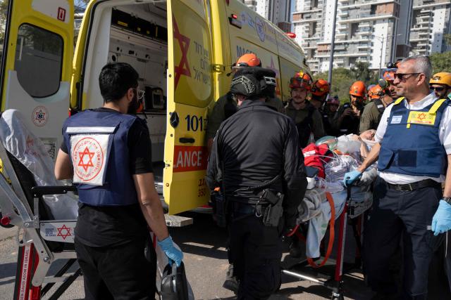 Rescue workers evacuate an elderly woman at the scene of an Iranian missile strike in Beer Sheva on March 2, 2026. The United States and Israel launched strikes against Iran on February 28, killing Iran's supreme leader and top military leaders, prompting authorities to retaliate with strikes on Israel and across the Gulf. (Photo by Maya Levin / AFP)