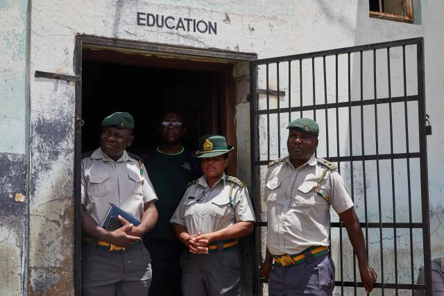 Prison guards watch proceedings at Harare Central Prison moments before Zimbabwe Justice Minister Ziyambi Ziyambi bids farewell to inmates who qualified to be released on March 2 2026. Zimbabwe on Monday began releasing nearly 4,000 inmates who were granted presidential amnesty in a bid to ease overcrowding in prisons.
The cabinet announced the amnesty in February on the same day it approved sweeping changes to the constitution as part of a plan to extend 83-year-old President Emmerson Mnangagwa's term till 2030.
"The nation should note that the release of the 3,978 beneficiaries begins today," Justice Minister Ziyambi Ziyambi said at a press conference in the capital Harare.
Zimbabwe's prisons held just over 24,000 inmates in the second quarter of 2025, according to recent available national data. (Photo by Jekesai NJIKIZANA / AFP)