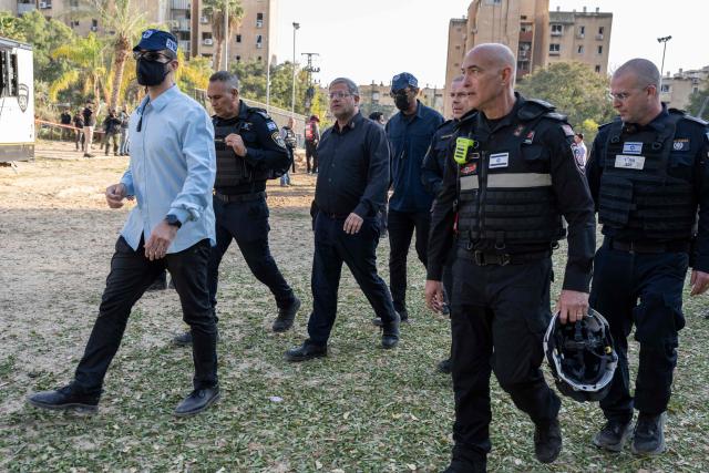 Far-right National Security Minister Itamar Ben Gvir (C) walks alongside security forces at the scene of an Iranian missile strike in Beersheva on March 2, 2026. The United States and Israel launched strikes against Iran on February 28, killing Iran's supreme leader and top military leaders, prompting authorities to retaliate with strikes on Israel and across the Gulf. (Photo by Maya Levin / AFP)