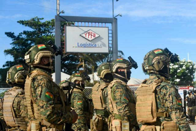 Military personnel guard the Palmasela fuel processing plant of Bolivian state-owned oil company YPFB in Santa Cruz, Bolivia, on March 2, 2026, with the aim of ensuring the continuity of gasoline production and distribution nationwide. The government deployed 1,500 troops to 16 strategic facilities to strengthen security and maintain control over fuel supplies across the country. (Photo by Rodrigo URZAGASTI / AFP)