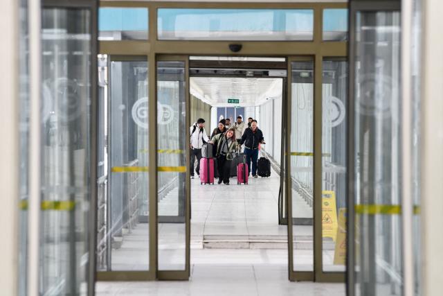 Iranian nationals arrive in Turkey through the Razi-Kapiköy border crossing, north-eastern Turkey in Van, on March 2, 2026, as Turkey and Iran have mutually suspended day-trip crossings at their border, Turkey's trade minister said as Israeli-US strikes continued to pound the Islamic Republic. (Photo by Ali IHSAN OZTURK / AFP)