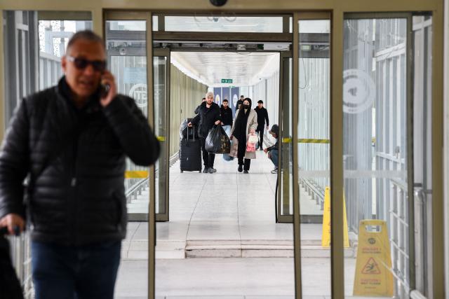 Iranian nationals arrive in Turkey through the Razi-Kapiköy border crossing, north-eastern Turkey in Van, on March 2, 2026, as Turkey and Iran have mutually suspended day-trip crossings at their border, Turkey's trade minister said as Israeli-US strikes continued to pound the Islamic Republic. (Photo by Ali IHSAN OZTURK / AFP)