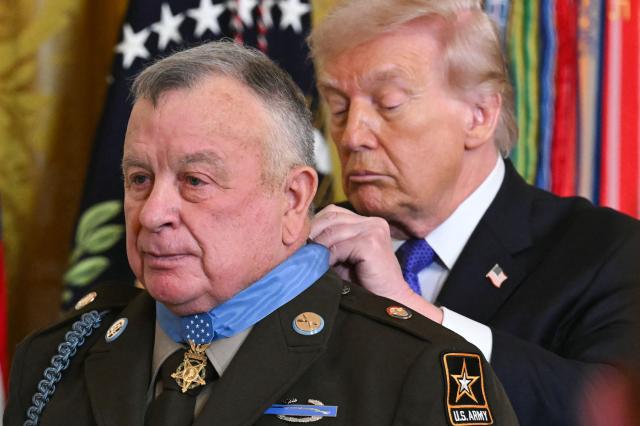 US President Donald Trump awards the Medal of Honor to retired Army Command Sgt. Major Terry P. Richardson during a ceremony in the East Room of the White House on March 2, 2026, in Washington, DC. President Trump awarded the Medal of Honor to retired Army Command Sgt. Major Terry P. Richardson, who served in the Vietnam War, posthumously to Army Master Sgt. Roderick W. Edmonds, who served in World War II, and posthumously to Staff Sgt. Michael Ollis, who died in combat in Afghanistan in 2013. (Photo by SAUL LOEB / AFP)